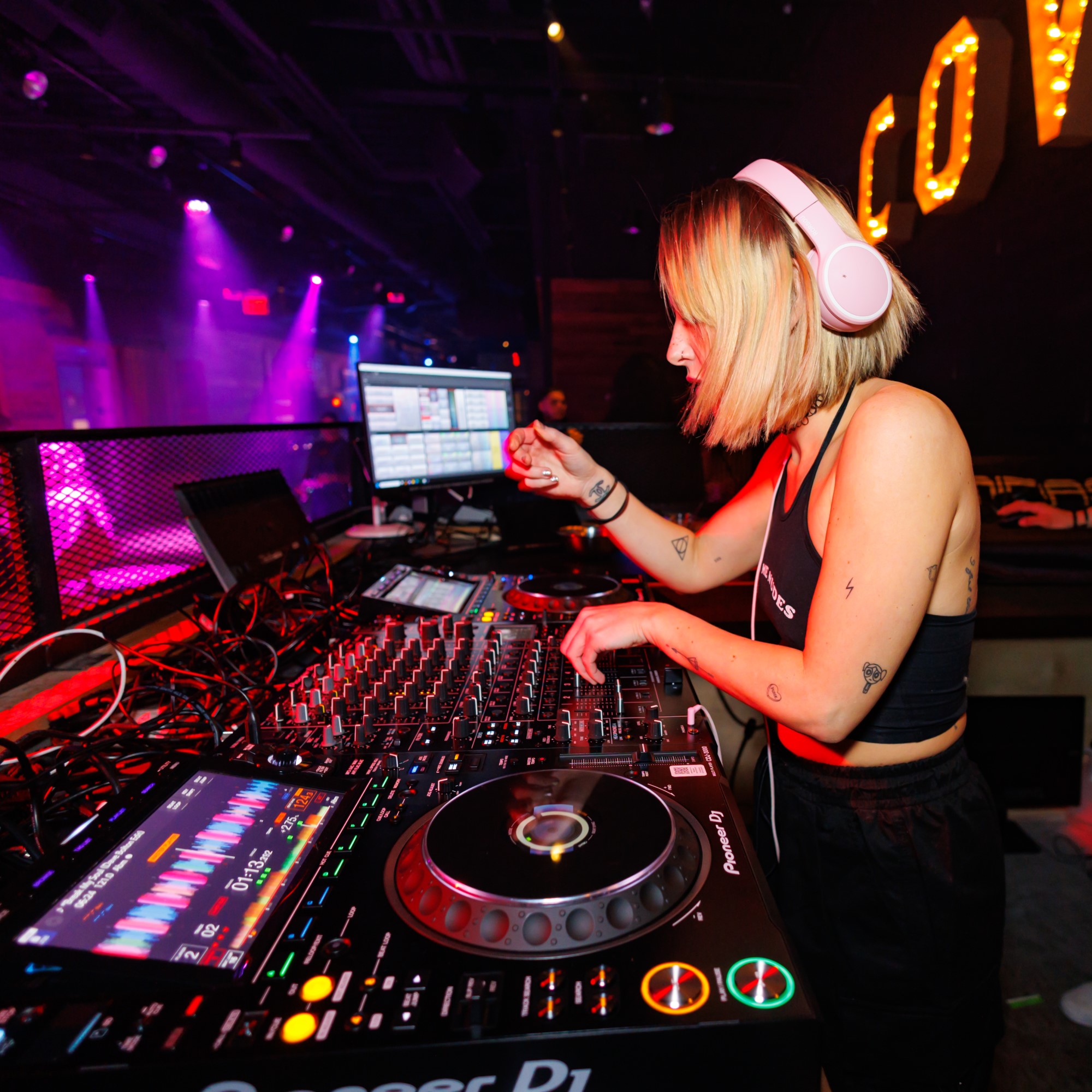 Female DJ at her board performing a set.