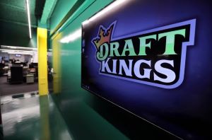 Draftkings Logo against a purple wall of an office.