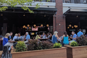 A Sports & Social location in downtown Atlanta showing outdoor and indoor dining and customers.